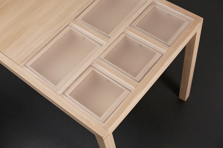 The central part of the table has a fixed surface, and materials can be stored on the left or right side