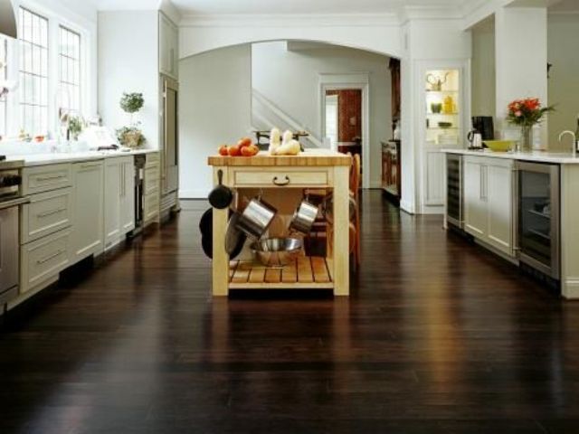 dark horizontal-grain bamboo floors lend drama and elegance in an open kitchen