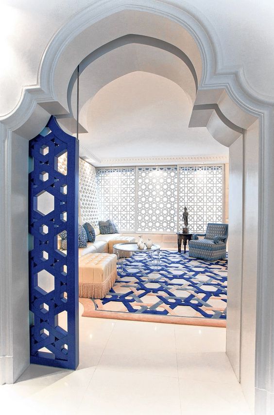 thick doorway with a Moroccan arch and blue styled door