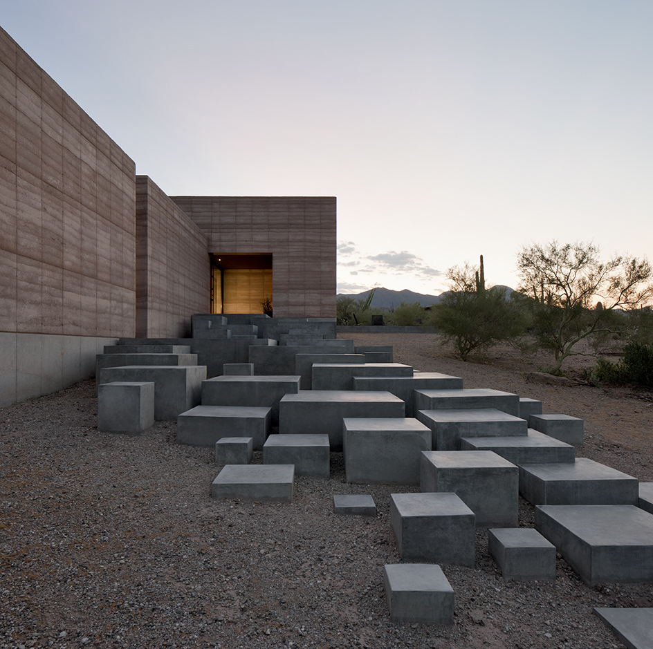 A series of sculptural concrete steps greets visitors and leads them to the main entrance