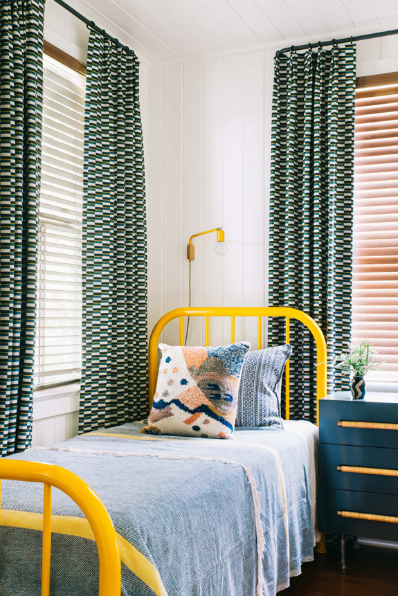 The guest bedroom is bolder and more colorful with yellow accents