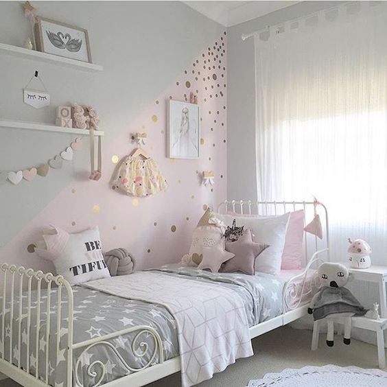 pastel girl's sleeping nook with toys and various wall decor