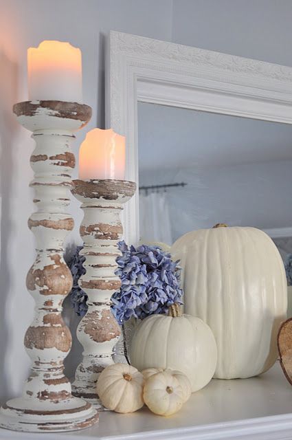 cream fall mantel with pumpkins and candles in shabby chic candle holders