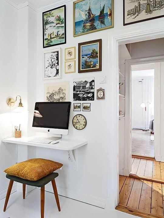 tiny corner used as an office nook with a wall-mounted desk