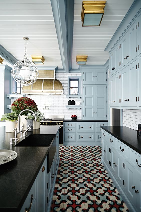 red, blue and cream floor tile creates an ambience in this kitchen