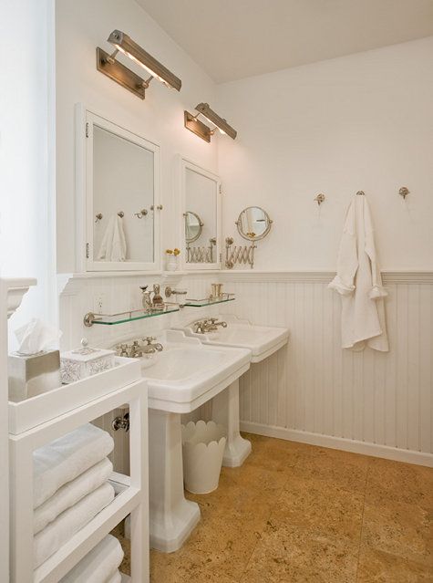 traditional white bathroom is highlighted with warm cork floors