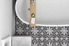 12 grey and white porcelain tiles create an eye-catchy touch in this bathroom