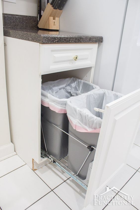 pull-out trash cans hidden in one of the ktichen cabinets
