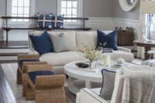 12 white wainscoting works well with grey walls in this coastal living room