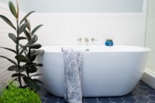 14 blue hexagon tiles and greenery make up the whole bathroom decor