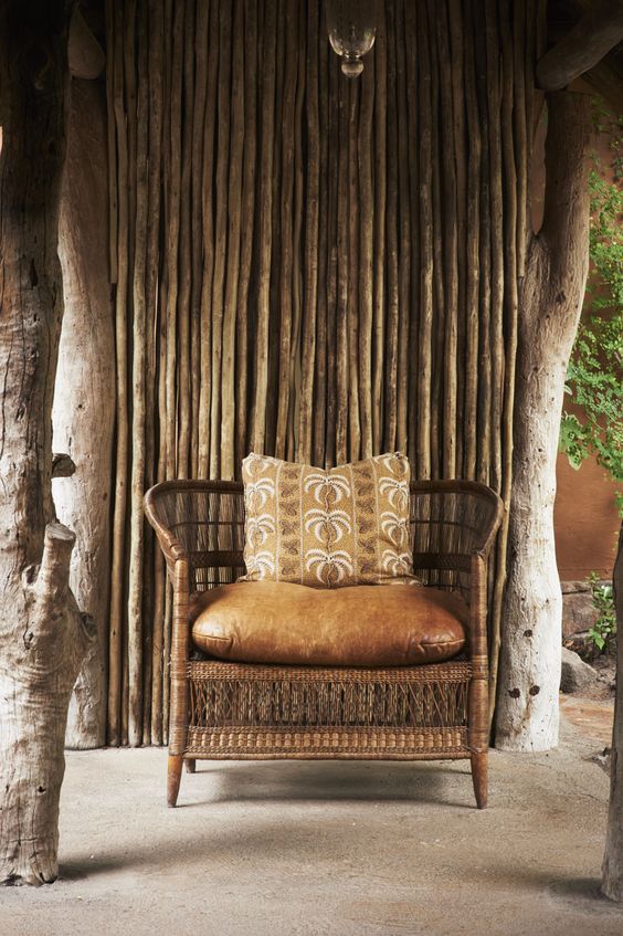 African-inspired chair of rattan and leather with an ethnic pillow