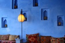 17 blue walls with niche lanterns and bright textiles