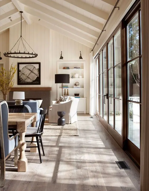 custom-stained oak hardwood flooring and white-washed exposed beams create a rustic ambiance