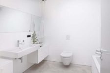 18 natural concrete floor for a clean all-white bathroom