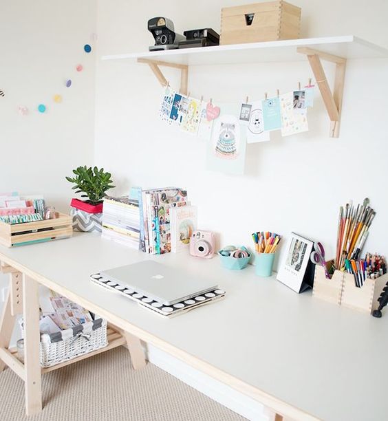 pastel creative space with an opne shelf and X leg desk