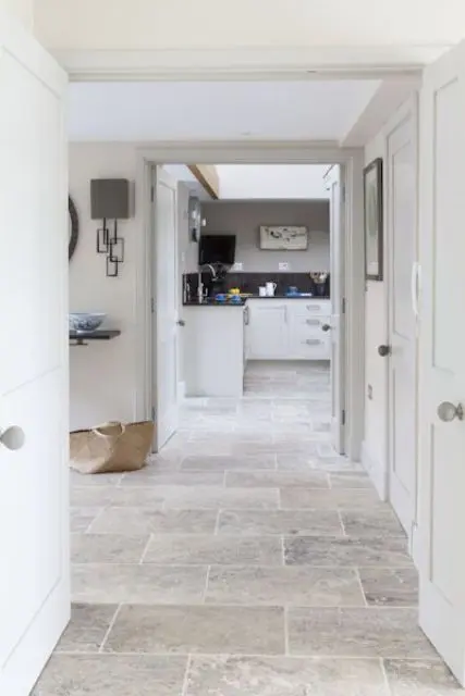 travertine hallway perfectly matches the interior and connect spaces