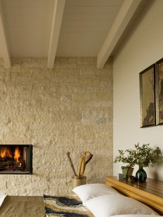 neutral bedroom decor with a textural fireplace wall