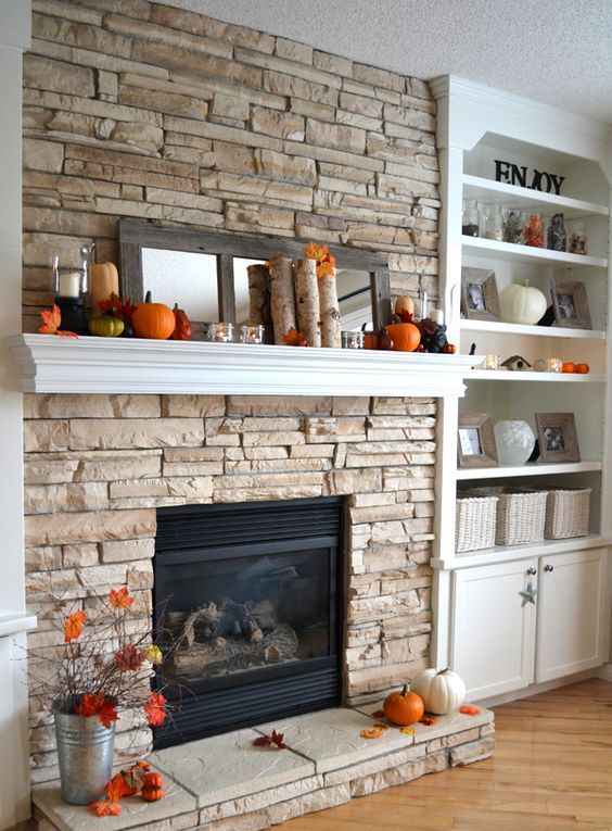 pumpkins, birch branches, faux leaves, modern candle holders and a mirror