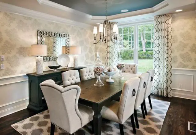 elegant dining space with patterned wallpapers and low wainscoting