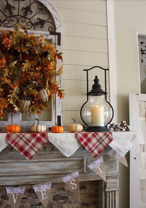 plaid and lace bunting, faux leaf and acorn wreath, small pumpkins and a candle lantern