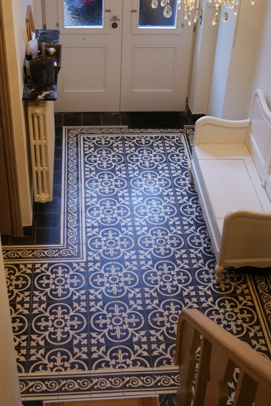 Portuguese tiles create an area rug look at the entryway