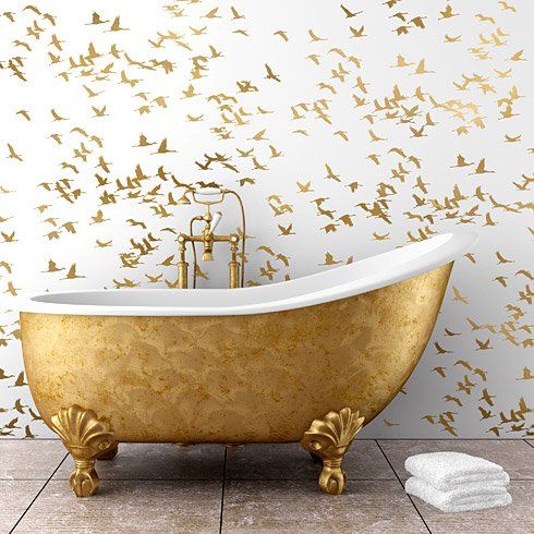 Gold cranes wallpaper echo with a free standing gold bathtub