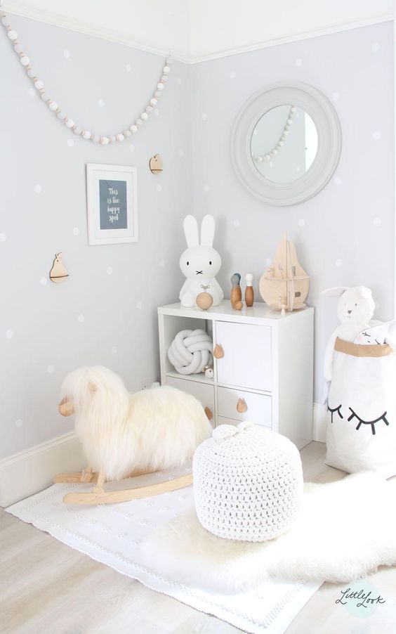 white play space with a sheep rocker and toys