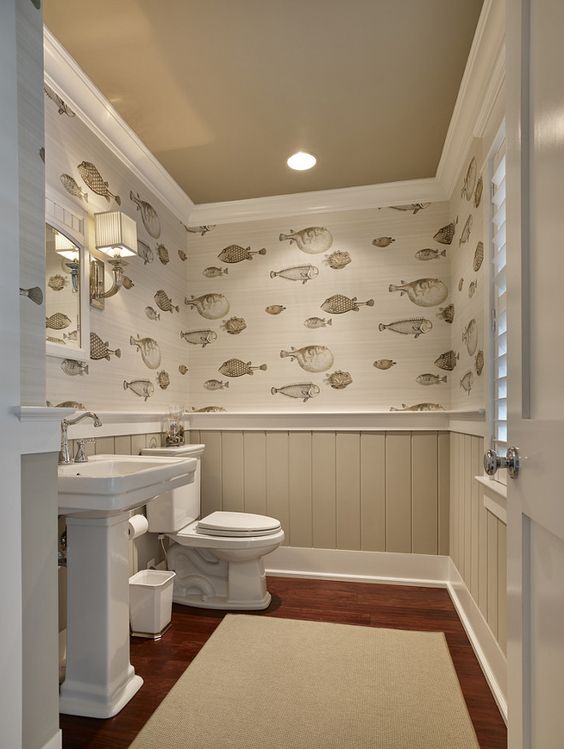 beige wainscoting with fish-patterned wallpaper