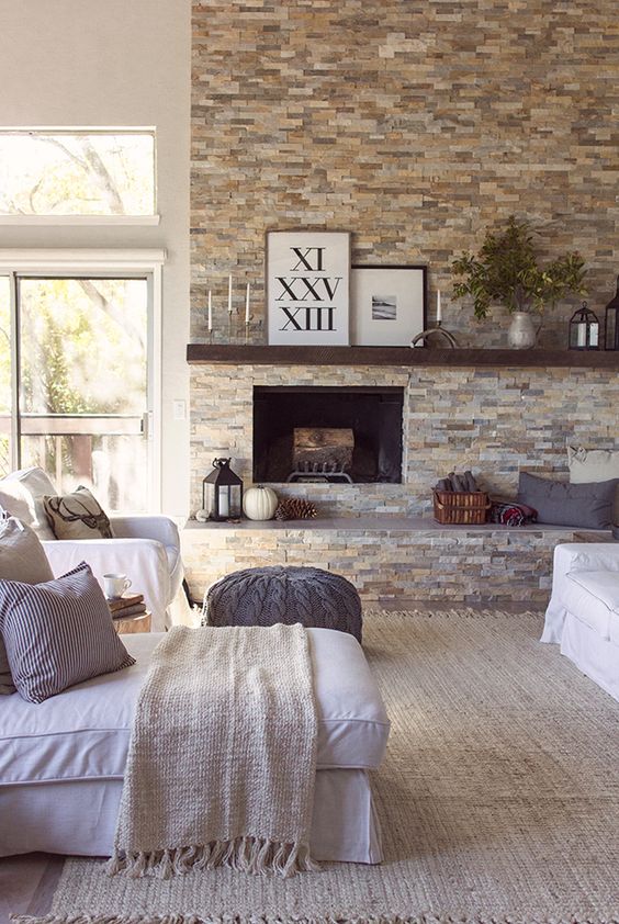 faux stone fireplace wall becomes a focal point in this cozy living room