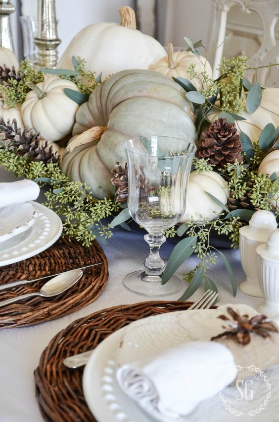 natural neutral-colored pumpkins and greenery for a centerpiece