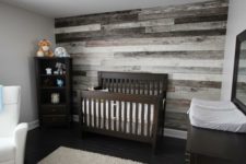 25 nursery with a reclaimed wood wall behind the bed for a rustic feel