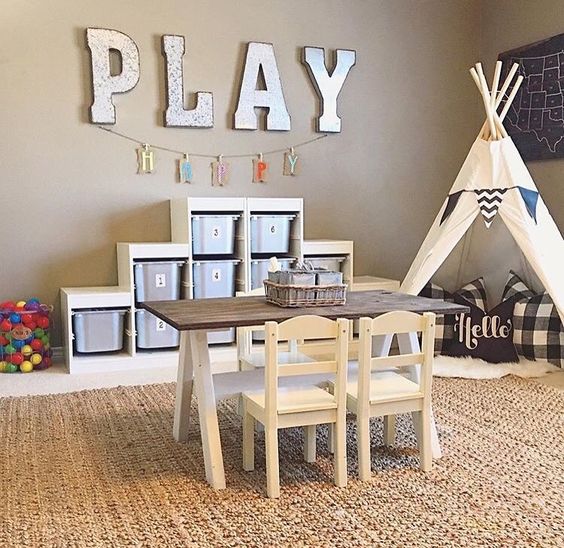 26 play area with a teepee, a table for drawing and a shelving unit with cubbies