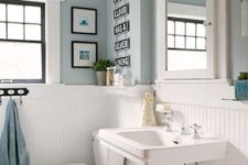 26 white wood panelling to make light blue bathroom more airy