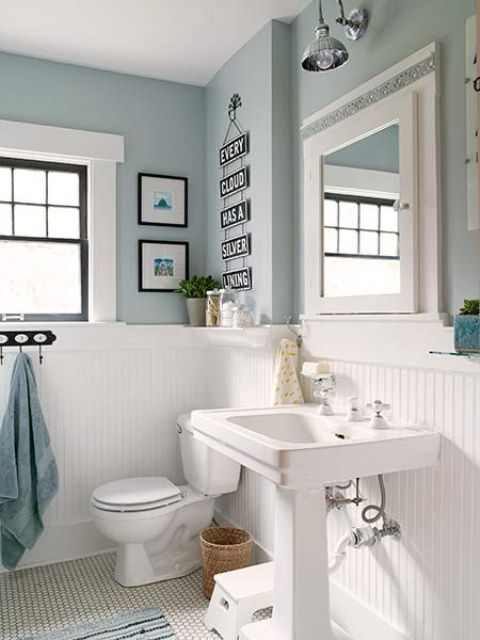 white wood panelling to make light blue bathroom more airy