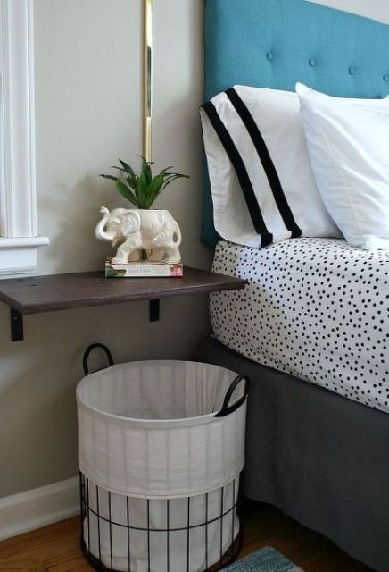 wall-mounted bedside table and a basket underneath