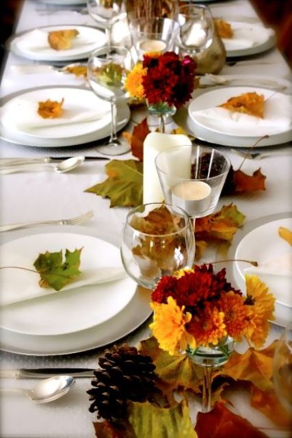 natural fall leaves, fall flowers and white procelain and candles