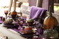 29 natural pumpkins for each place, large ones for decor, a purple table runner, fall leaves as chargers