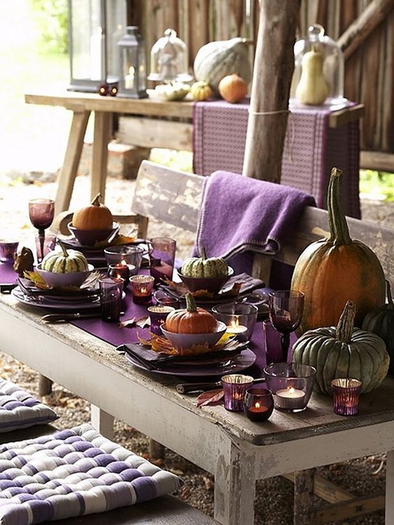 natural pumpkins for each place, large ones for decor, a purple table runner, fall leaves as chargers