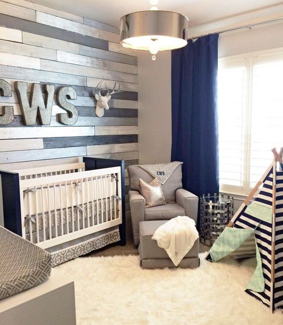 metallic wood wall perfectly accentuates a navy and grey nursery