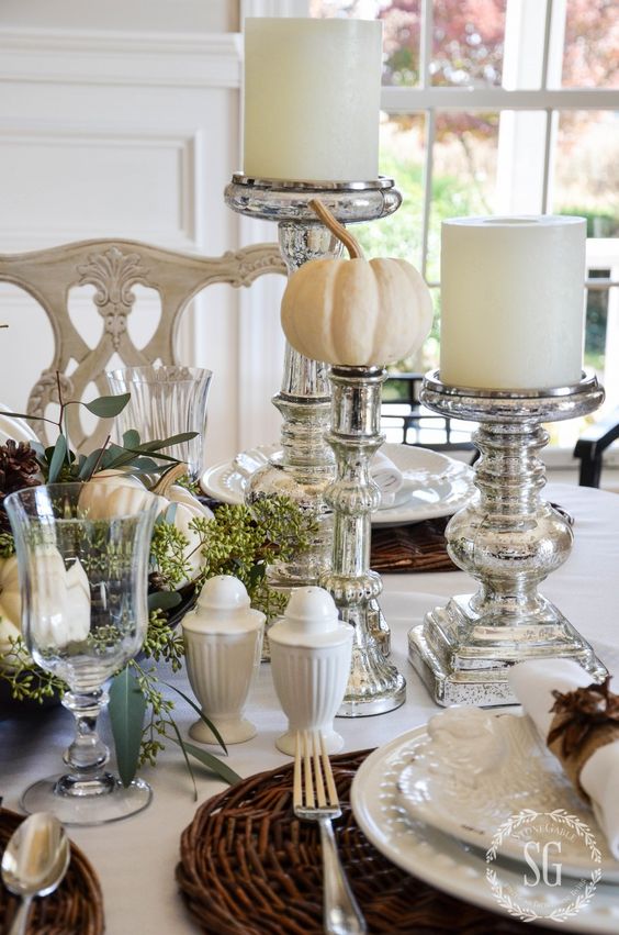 silver candle holders and pumpkin stands, woven chargers and white porcelain