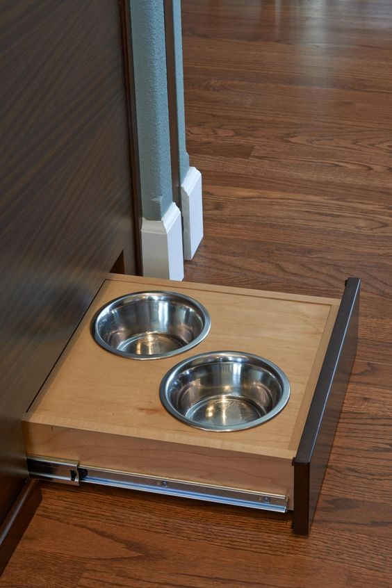 a pair of bowls can be pulled out from beneath the kitchen island