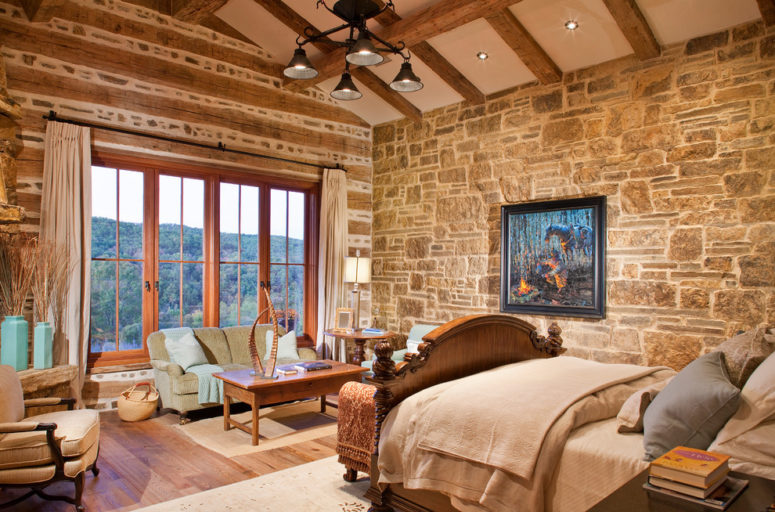 Natural stone wall looks great combined with exposed beams and pine flooring. (WoodCo)