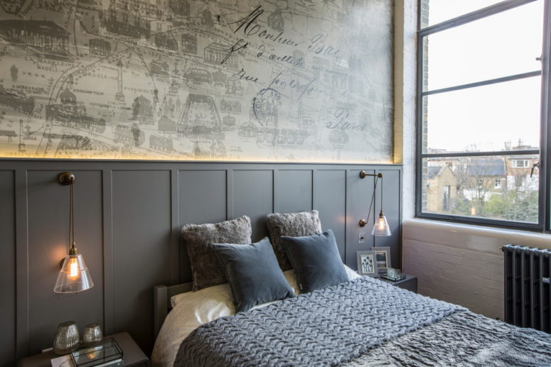 Dark grey wainscoting acts as a headboard in this contemporary bedroom. (Milward Teverini)