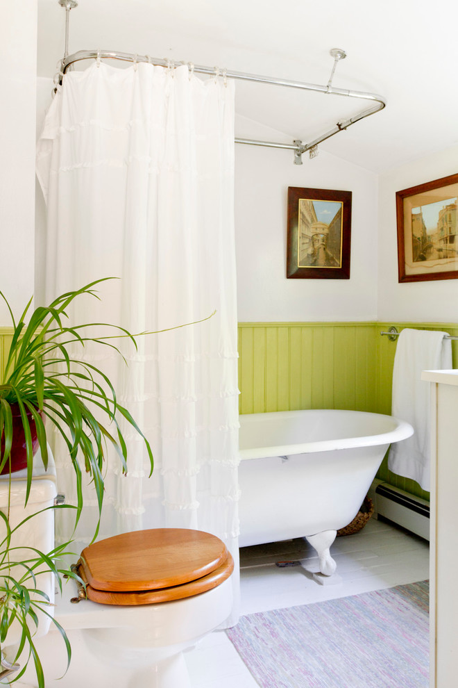 Green wainscoting creates contrast in this neutral-looking bathroom. (Rikki Snyder)