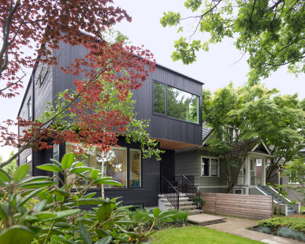 Modern house clad in thin strips of black cedar with a sculptural feel