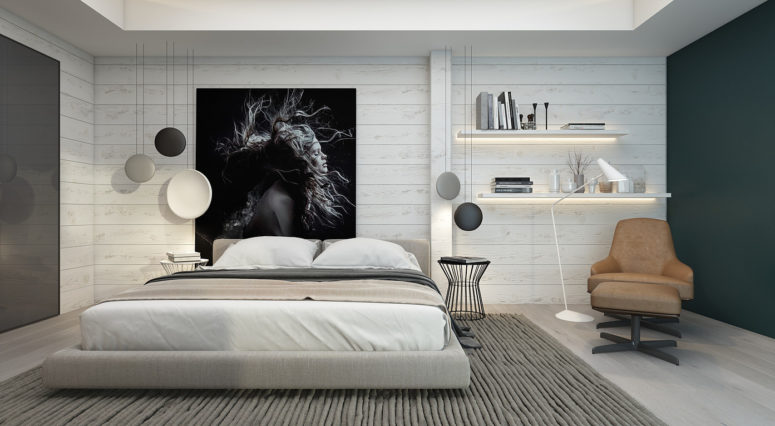 The master bedroom is clad with whitewashed wood and there's a cool oversized black and white artwork