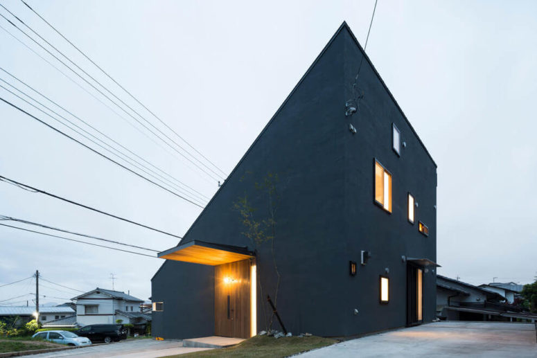 This minimalist home has a unique angular look and is painted grey on the outside