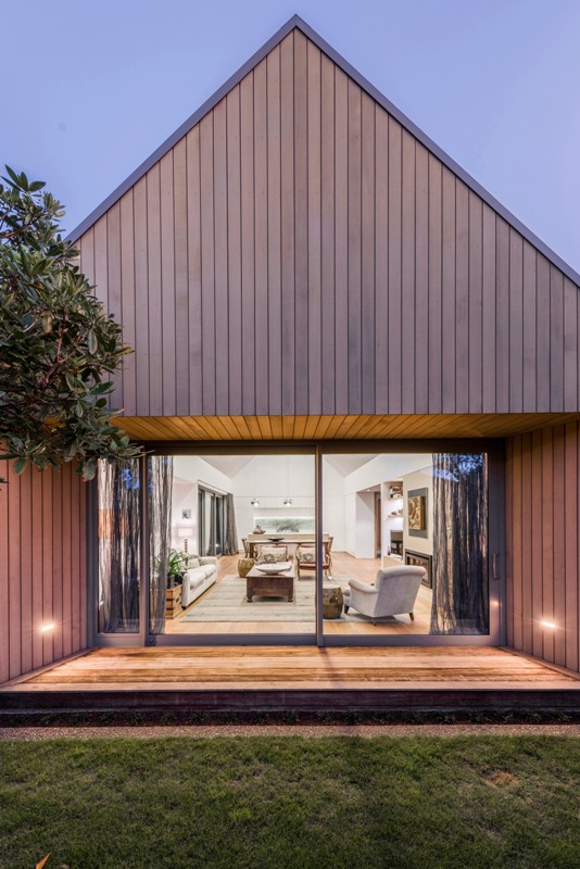 This modern cedar clad home reminds of an English country house with a gabled roof