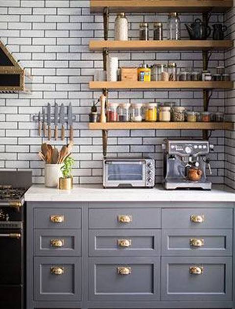 The kitchen is the focal point for certain reasons, it has grey mid century cabinets with gold handles