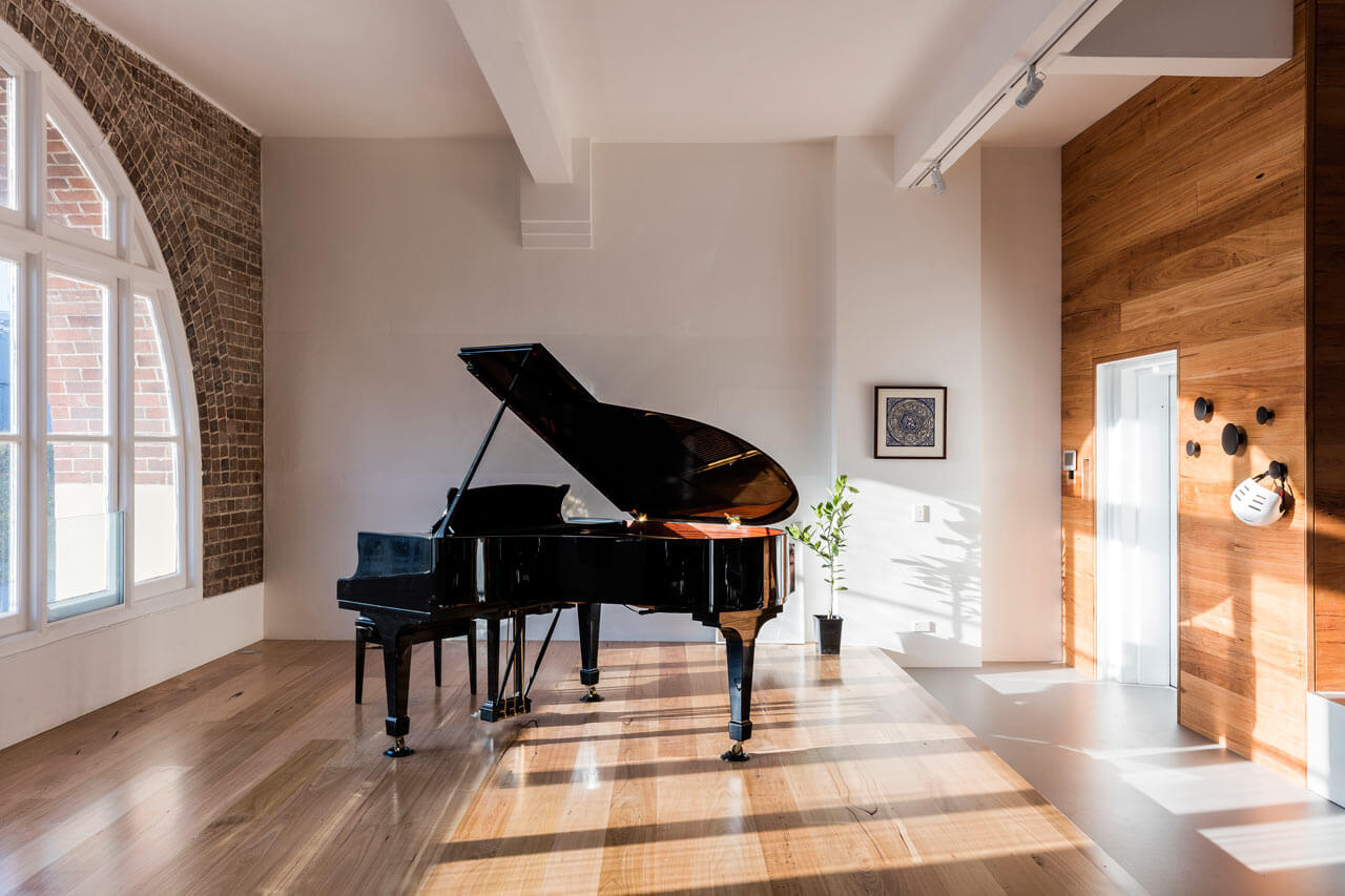 There's no better place for a large piano than a cool brick corner filled with light